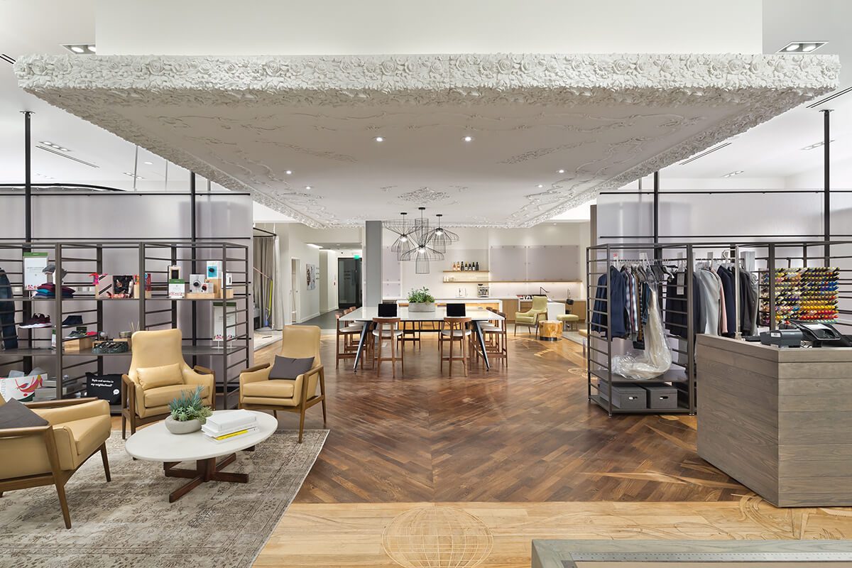 Retail showroom with sculpted plaster ceiling and herringbone wood floor