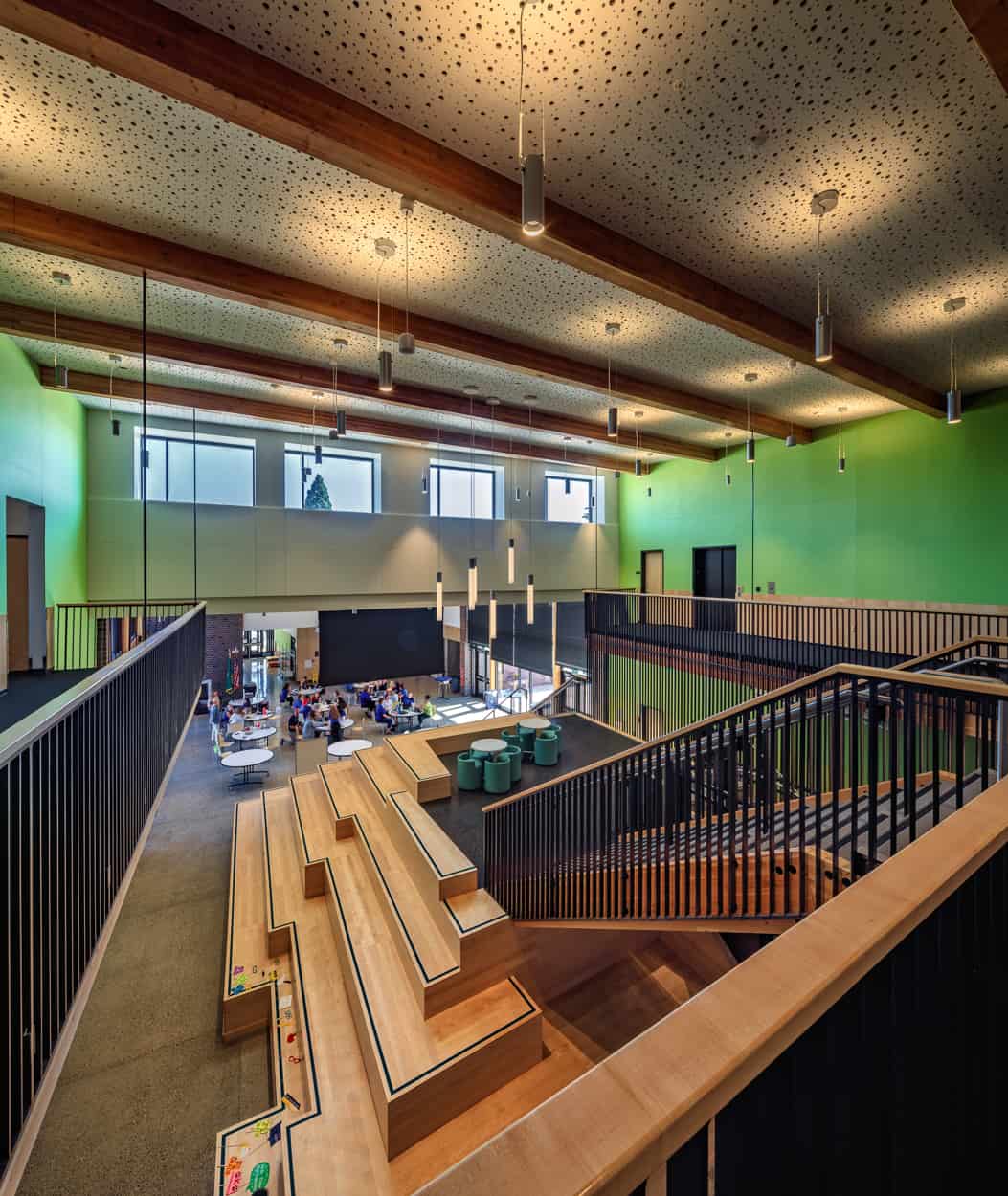 School commons with wood learning stair and timber beams